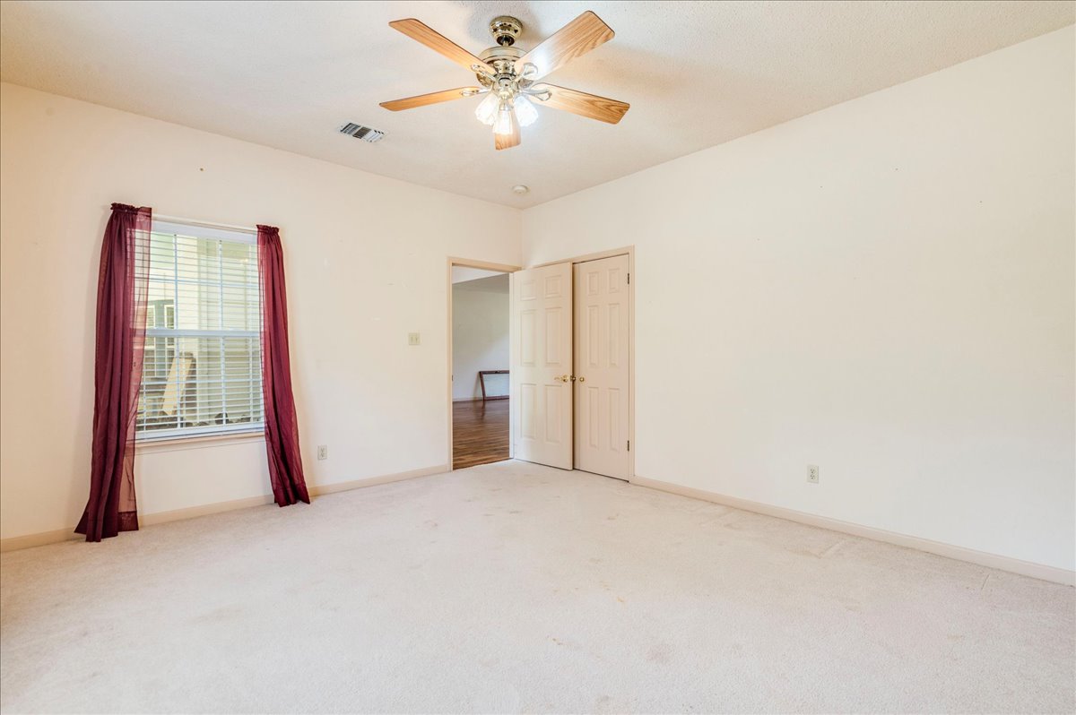19106 Eyerley Road Manor, TX 78653 - Photo 19 of 40 second bedroom offers ample space, soft carpeting, and a gentle ceiling fan for comfort.