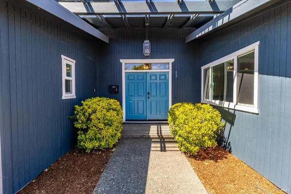 a kitchen with a stove a microwave a sink and cabinets
