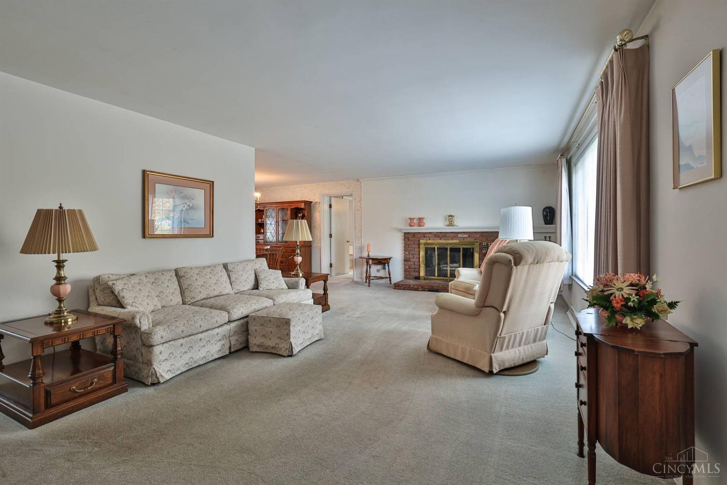8898 Raiders Run Road Cincinnati, OH 45236 - Photo 3 of 32 Living room and dining room offers hardwood floors under carpet. The fireplace has not been used and is not warranted