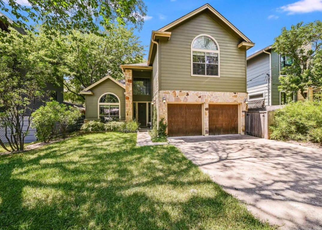 a front view of a house with a yard and garage