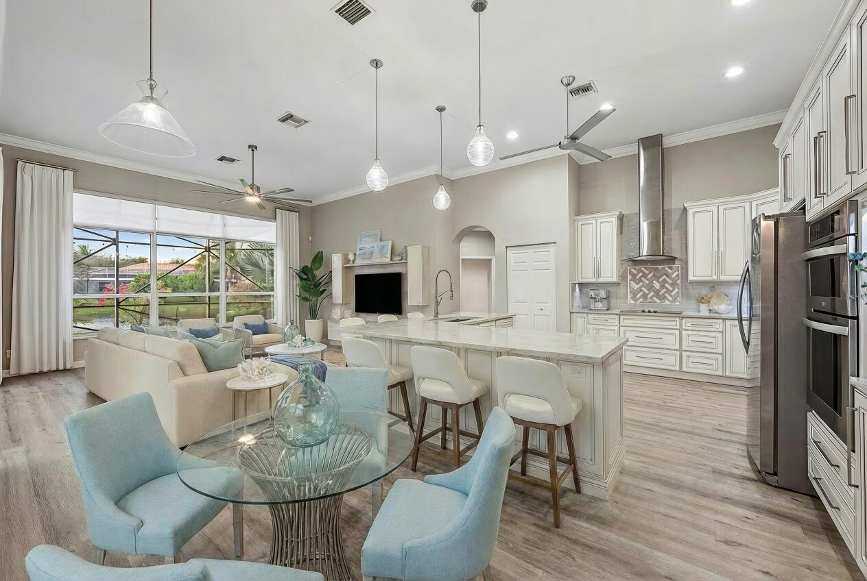 9790 Southeast Crape Myrtle Court Hobe Sound, FL 33455 - Photo 12 of 74 a large kitchen with a table and chairs