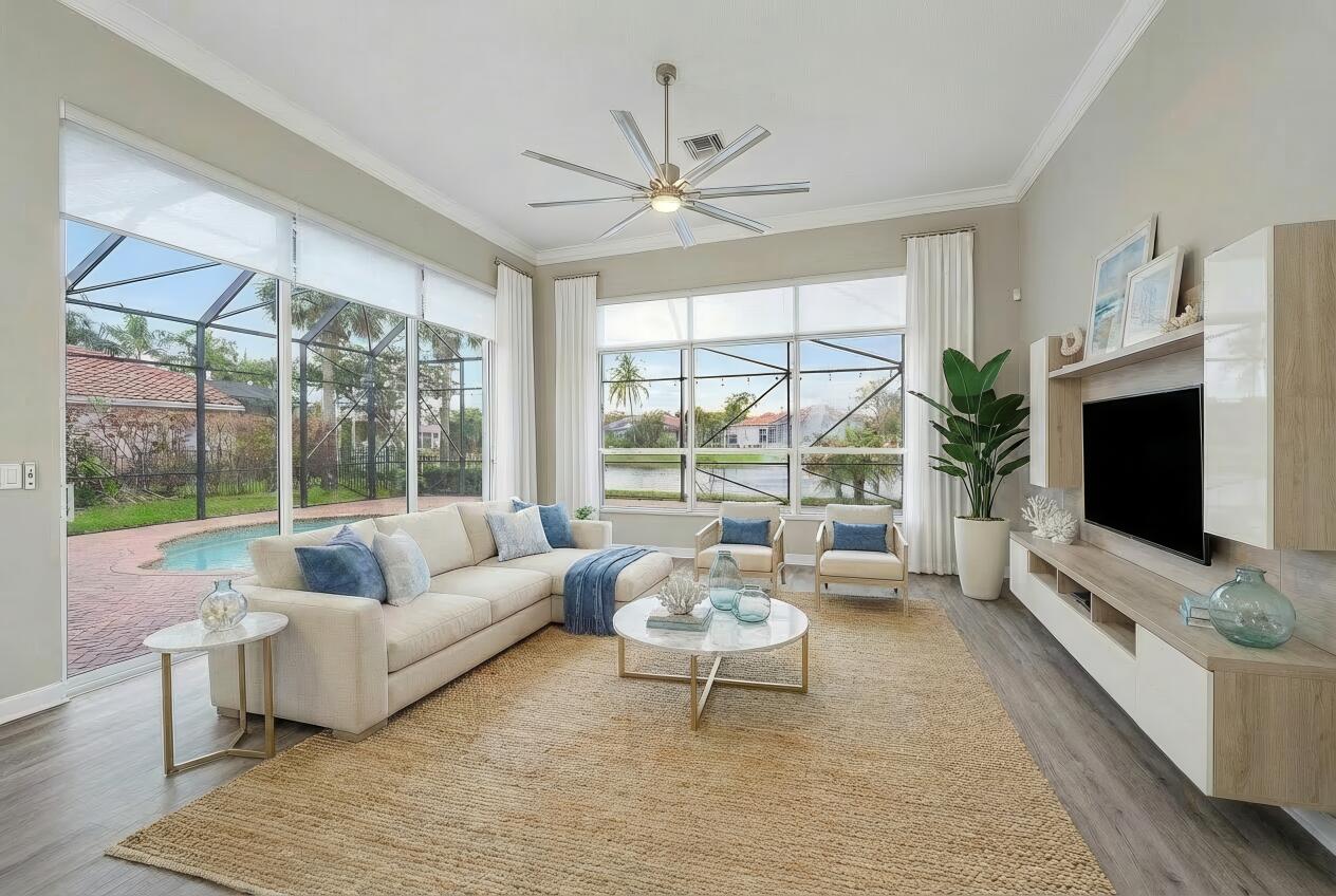 9790 Southeast Crape Myrtle Court Hobe Sound, FL 33455 - Photo 14 of 74 a living room with furniture tv and a large window