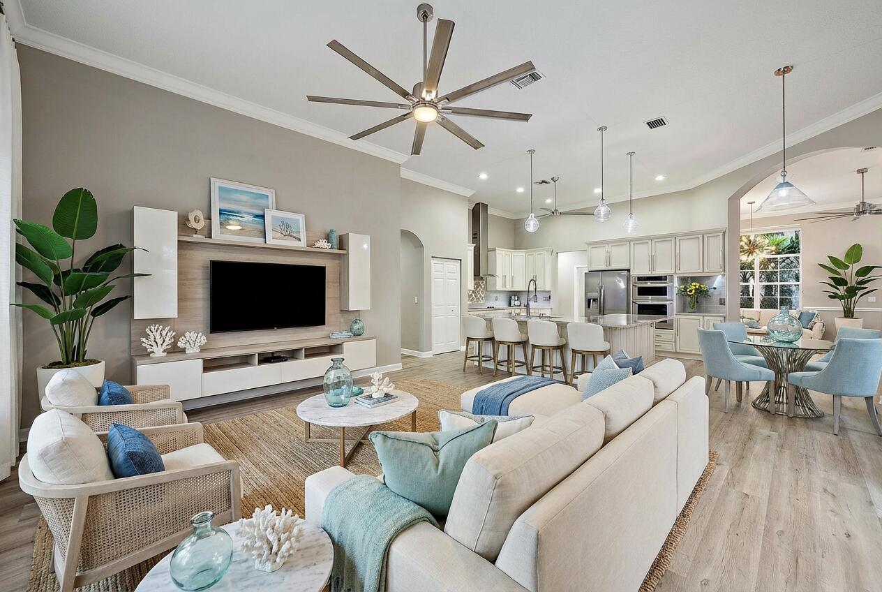 9790 Southeast Crape Myrtle Court Hobe Sound, FL 33455 - Photo 15 of 74 a living room with furniture kitchen view and a flat screen tv