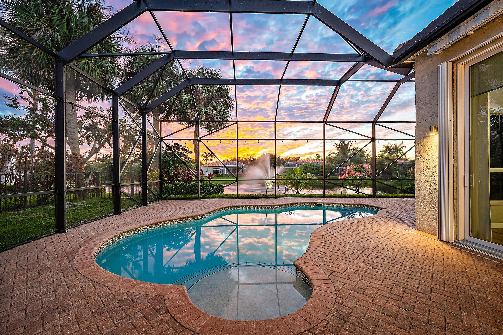 9790 Southeast Crape Myrtle Court Hobe Sound, FL 33455 - Photo 2 of 74 a view of a swimming pool with a patio