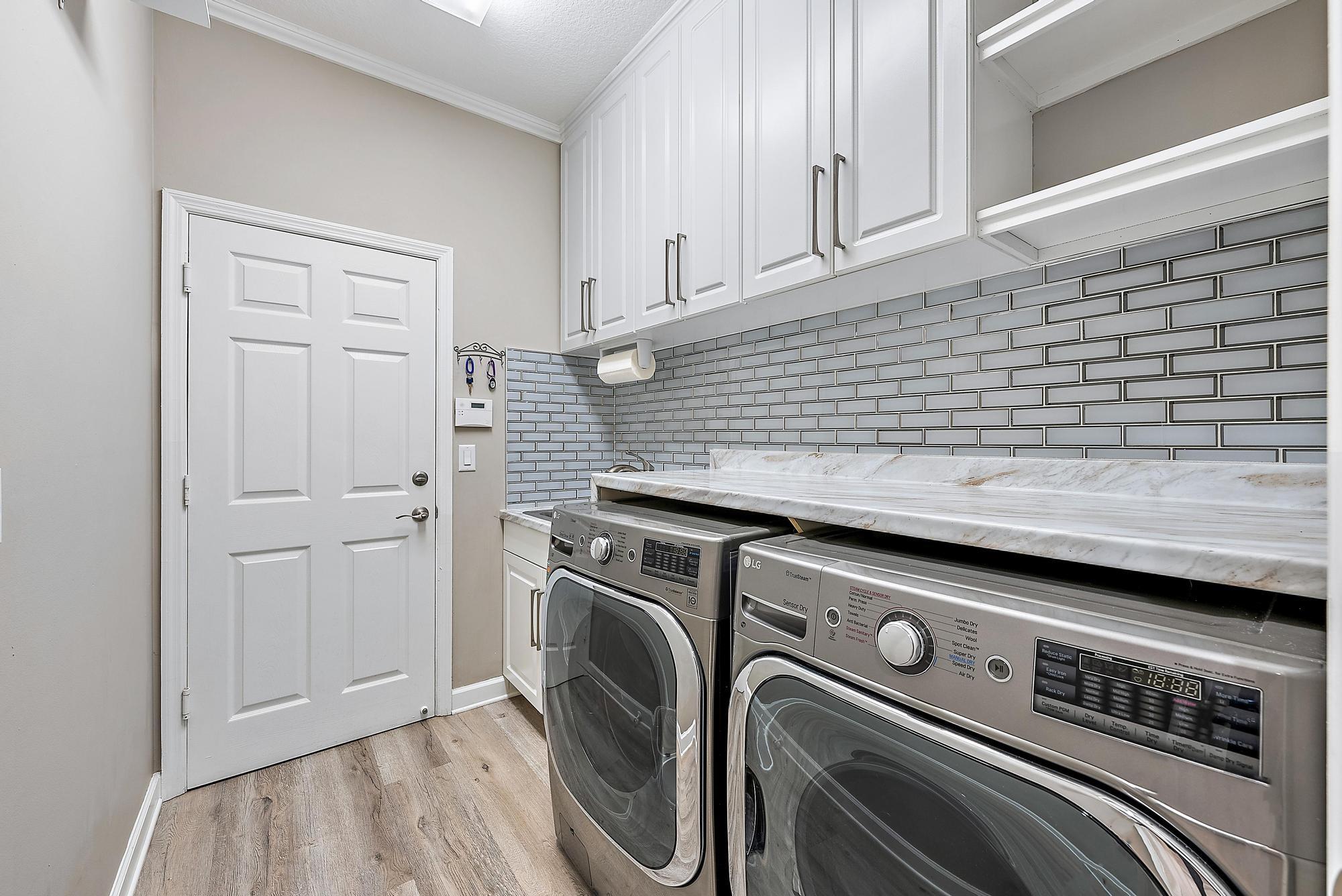 9790 Southeast Crape Myrtle Court Hobe Sound, FL 33455 - Photo 22 of 74 a utility room with dryer and washer