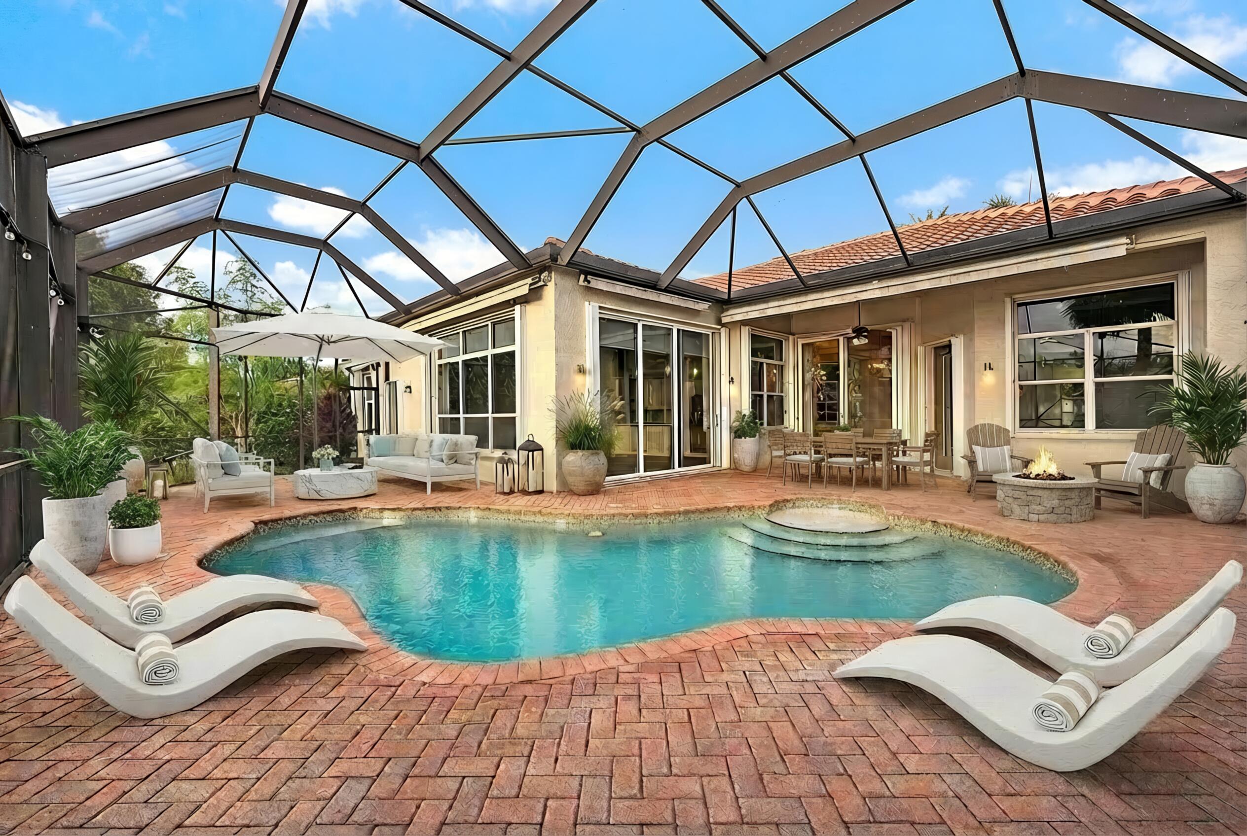 9790 Southeast Crape Myrtle Court Hobe Sound, FL 33455 - Photo 29 of 74 a view of a house with swimming pool and sitting area