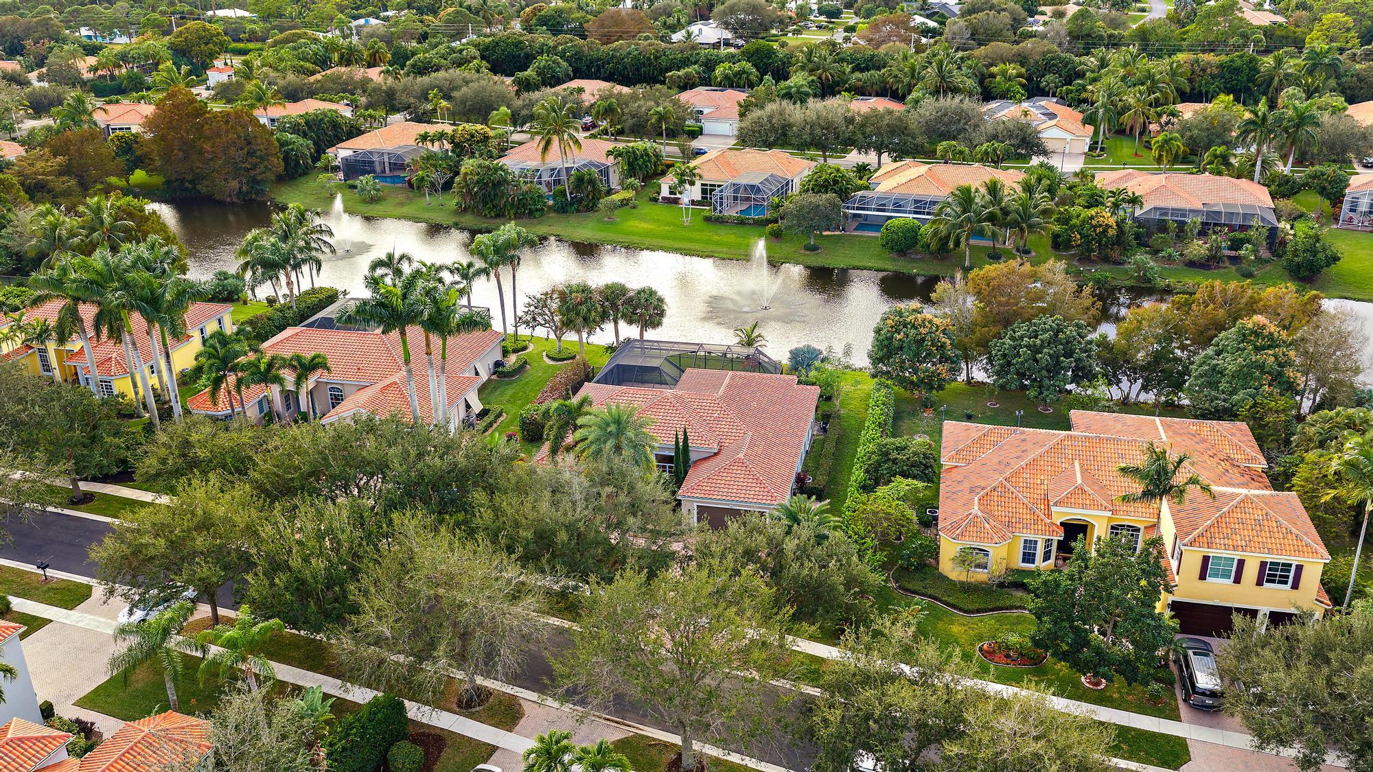 9790 Southeast Crape Myrtle Court Hobe Sound, FL 33455 - Photo 32 of 74 an aerial view of residential houses with outdoor space and trees