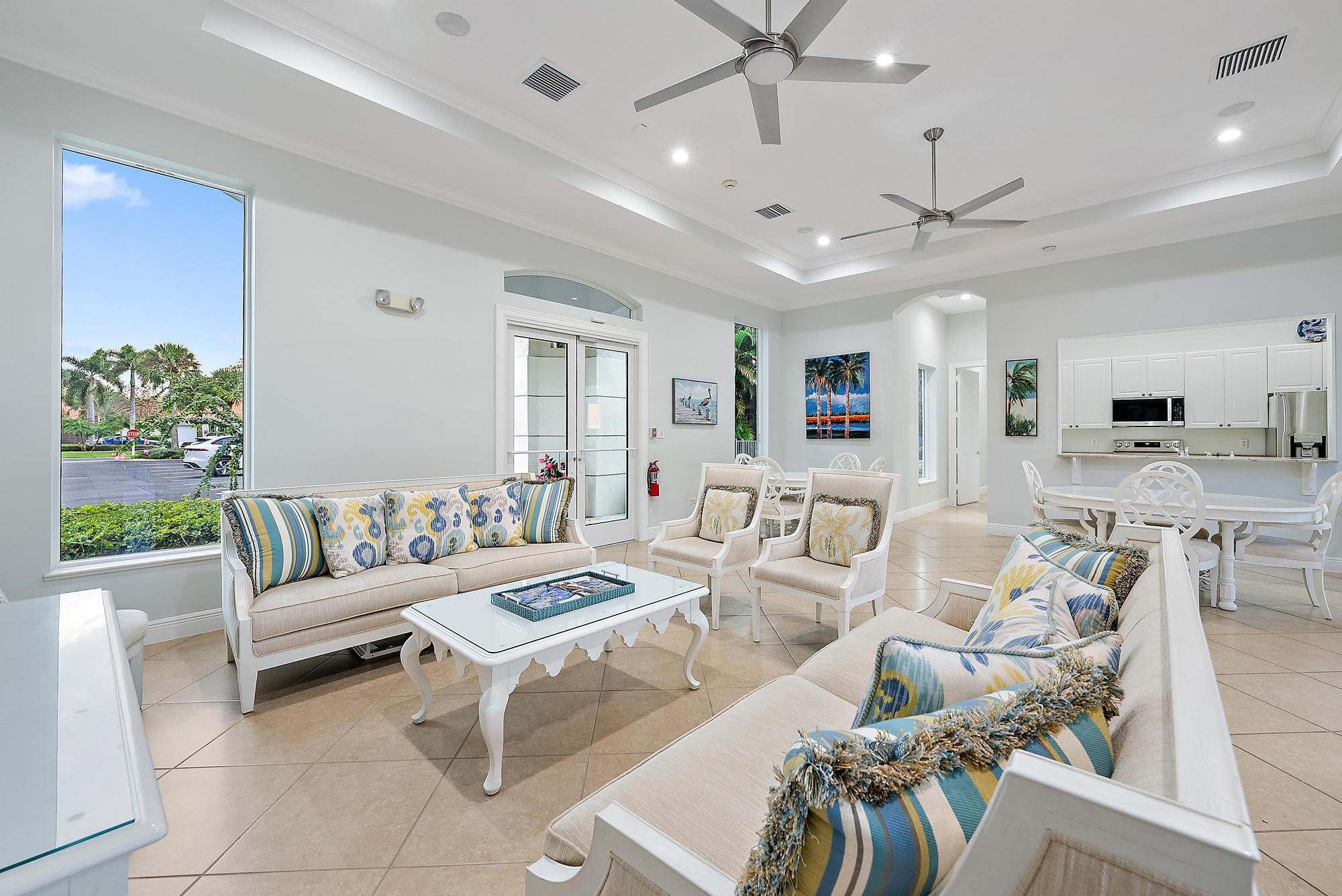 9790 Southeast Crape Myrtle Court Hobe Sound, FL 33455 - Photo 40 of 74 a living room with furniture kitchen view and a chandelier