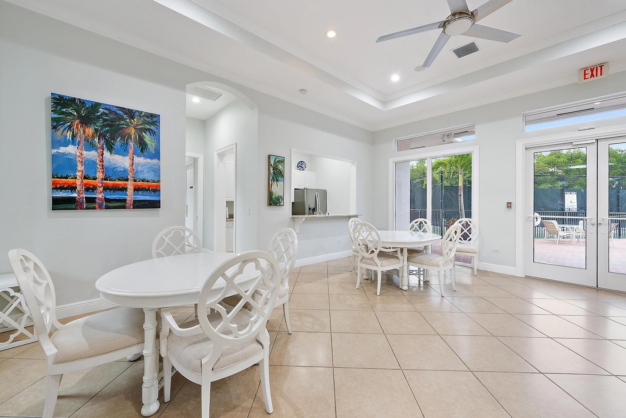 9790 Southeast Crape Myrtle Court Hobe Sound, FL 33455 - Photo 41 of 74 a view of a dining room with furniture and a floor to ceiling window
