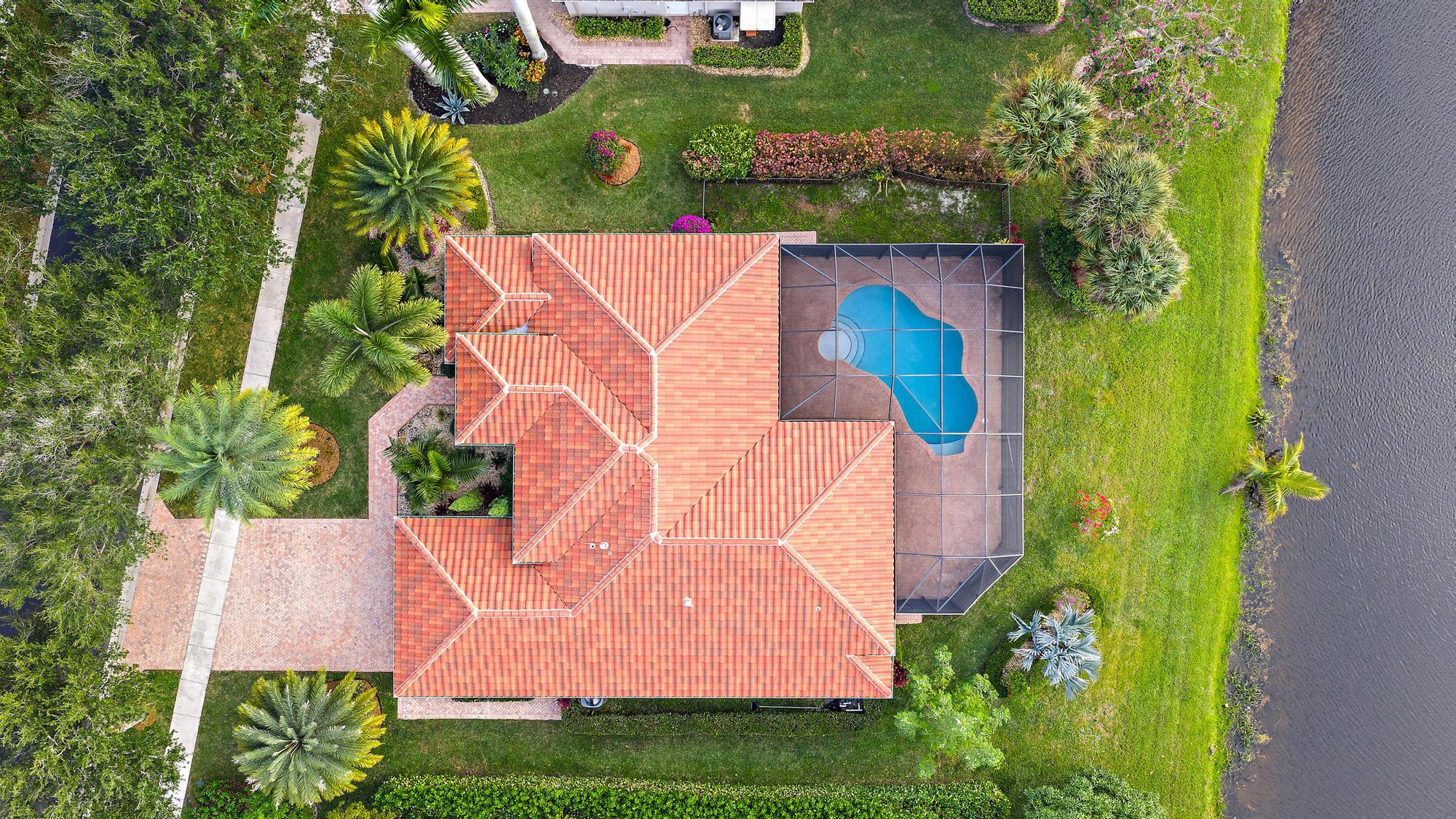 9790 Southeast Crape Myrtle Court Hobe Sound, FL 33455 - Photo 5 of 74 an aerial view of house with yard swimming pool and outdoor seating