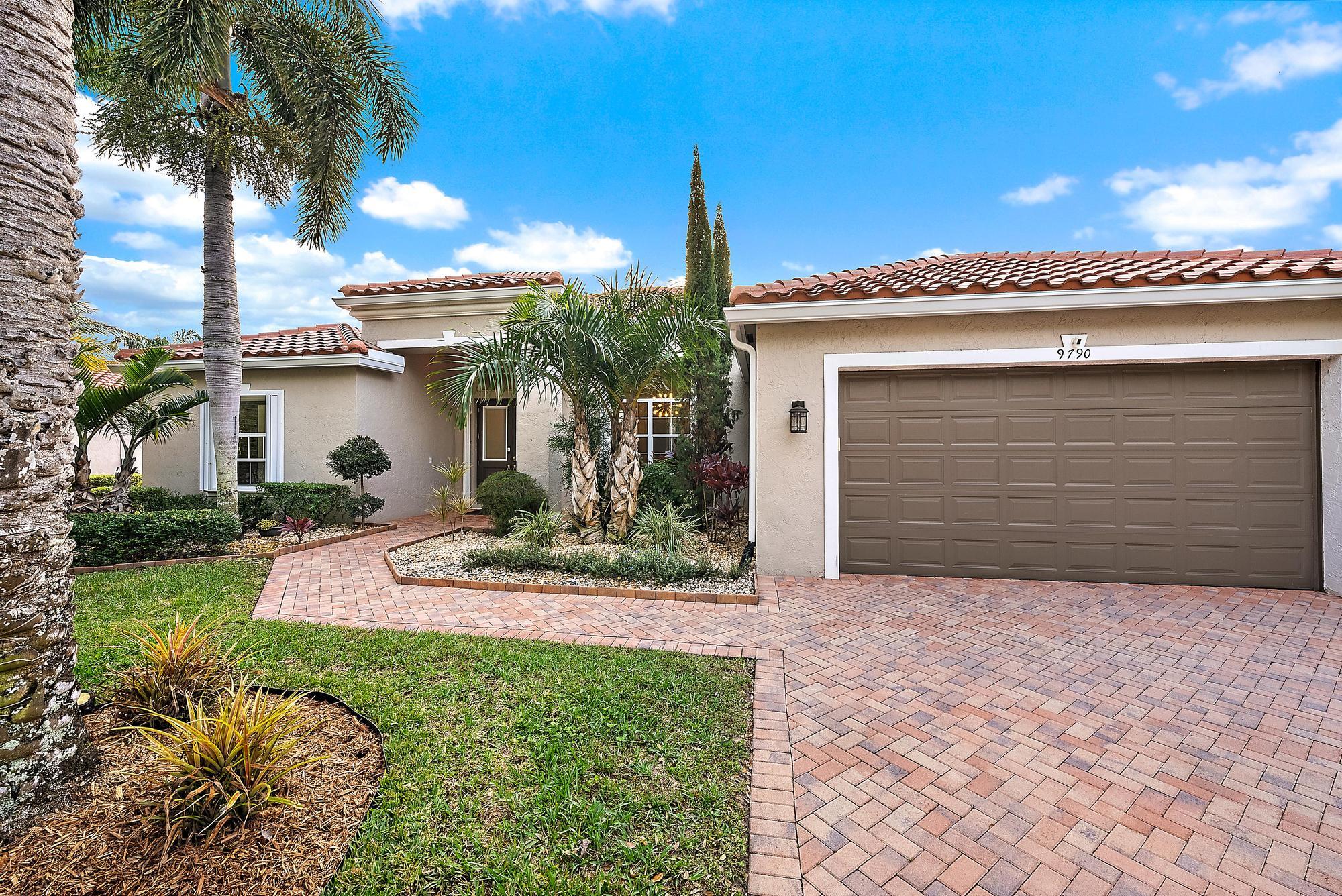 9790 Southeast Crape Myrtle Court Hobe Sound, FL 33455 - Photo 54 of 74 a front view of a house with garden