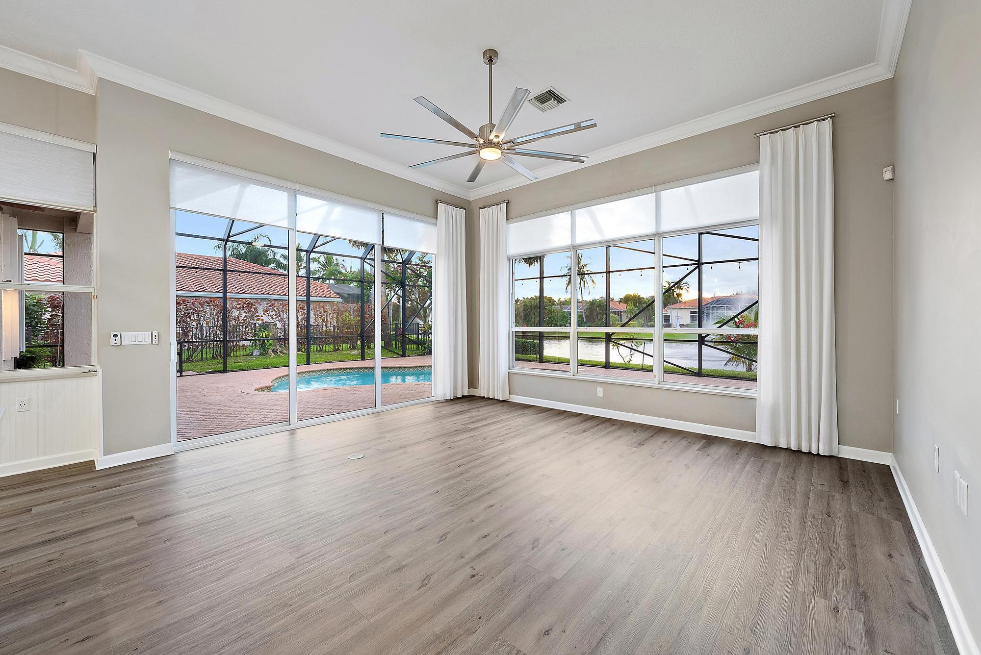 9790 Southeast Crape Myrtle Court Hobe Sound, FL 33455 - Photo 59 of 74 a view of room with wooden floor and fan