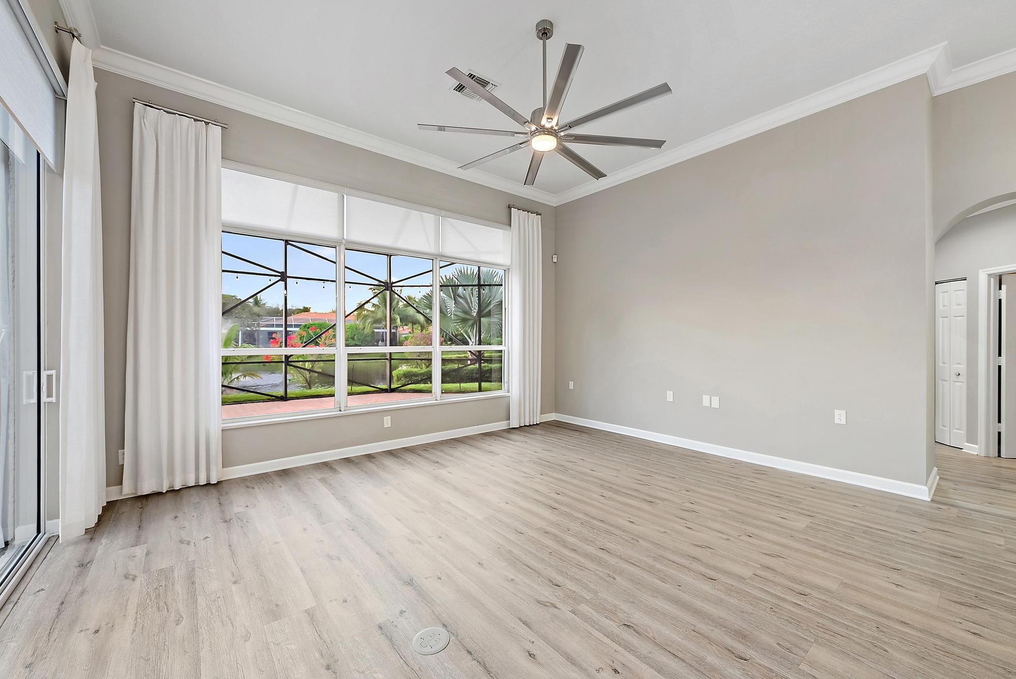 9790 Southeast Crape Myrtle Court Hobe Sound, FL 33455 - Photo 60 of 74 a view of an empty room with a window and wooden floor