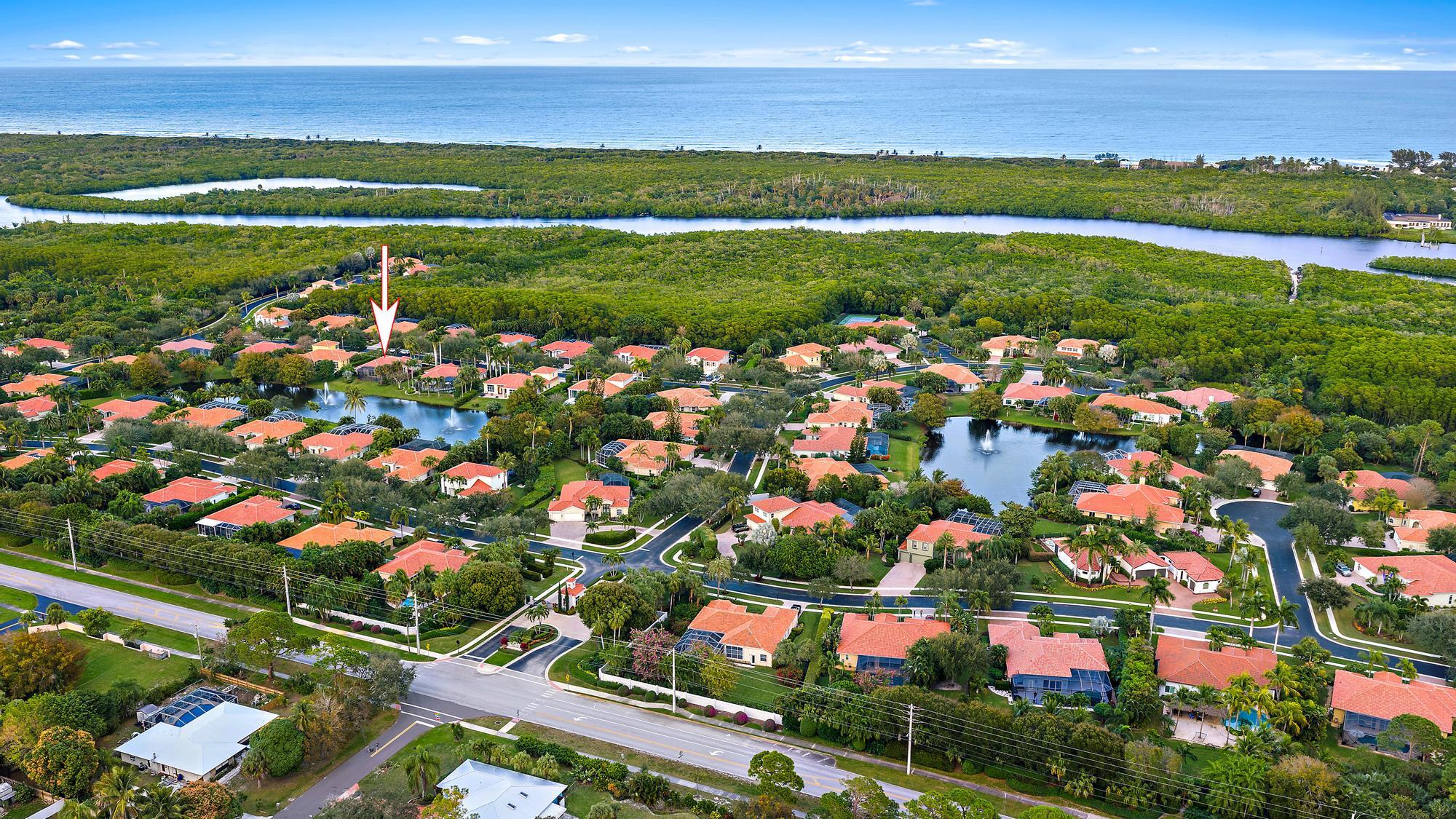 9790 Southeast Crape Myrtle Court Hobe Sound, FL 33455 - Photo 6 of 74 a view of a city with an ocean and trees in the background
