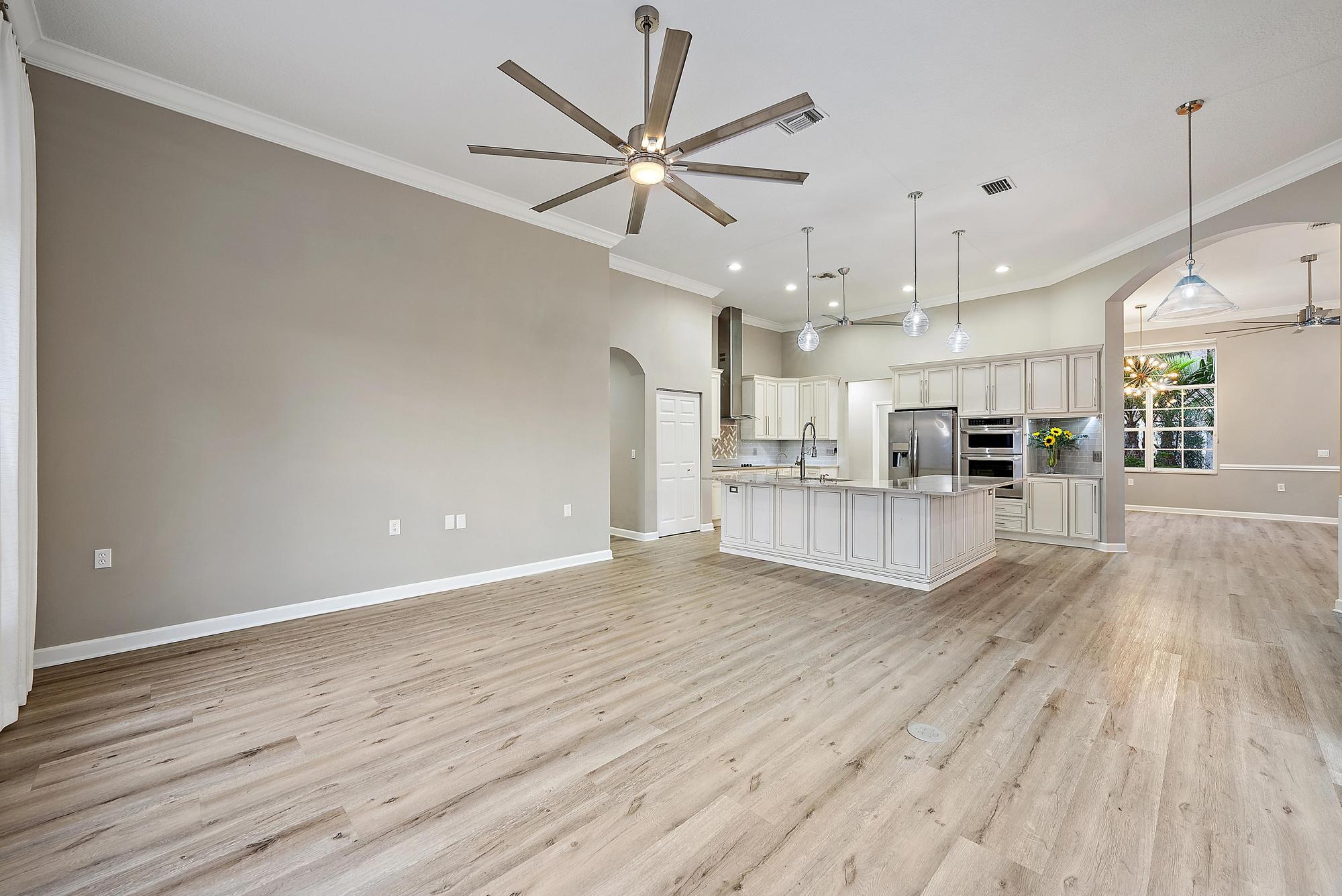 9790 Southeast Crape Myrtle Court Hobe Sound, FL 33455 - Photo 61 of 74 a view of a kitchen with a sink and wooden floor