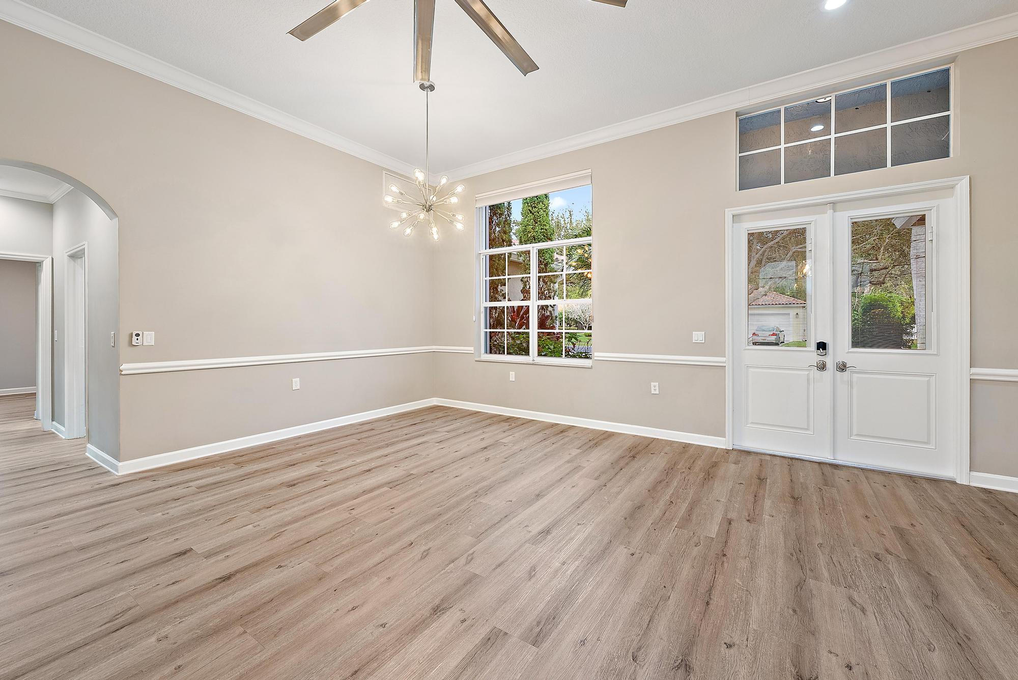 9790 Southeast Crape Myrtle Court Hobe Sound, FL 33455 - Photo 64 of 74 a view of an empty room with wooden floor and a window