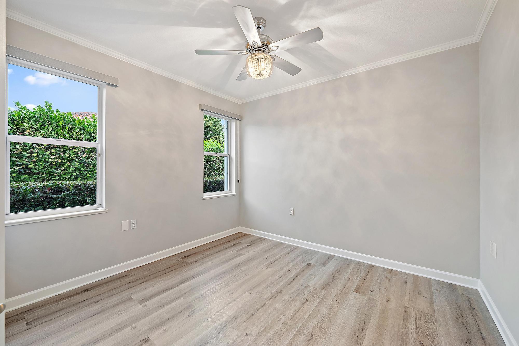 9790 Southeast Crape Myrtle Court Hobe Sound, FL 33455 - Photo 66 of 74 a view of an empty room with a window and wooden floor