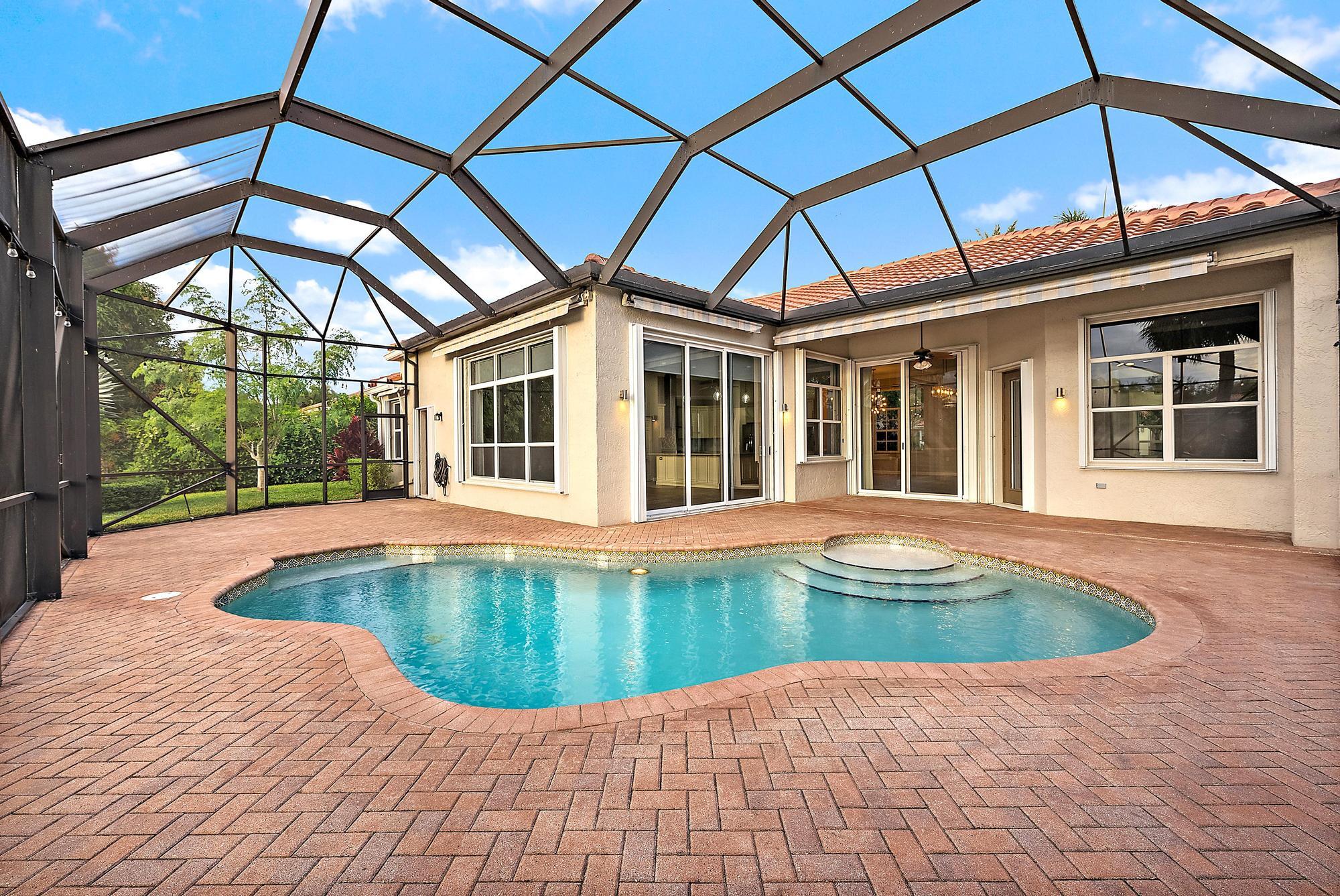 9790 Southeast Crape Myrtle Court Hobe Sound, FL 33455 - Photo 68 of 74 a view of pool with a house in the background