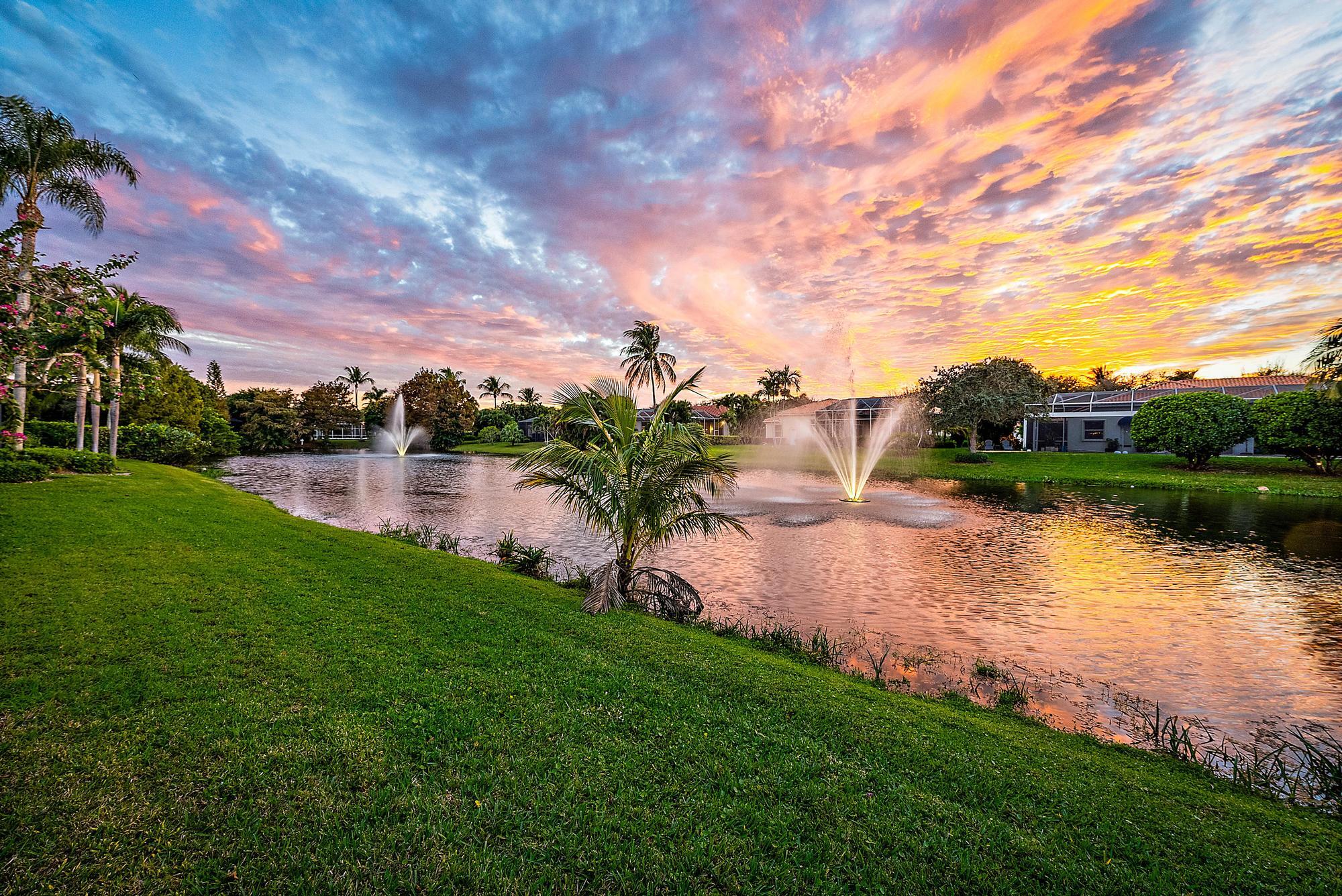 9790 Southeast Crape Myrtle Court Hobe Sound, FL 33455 - Photo 70 of 74 a view of a lake with houses in the back