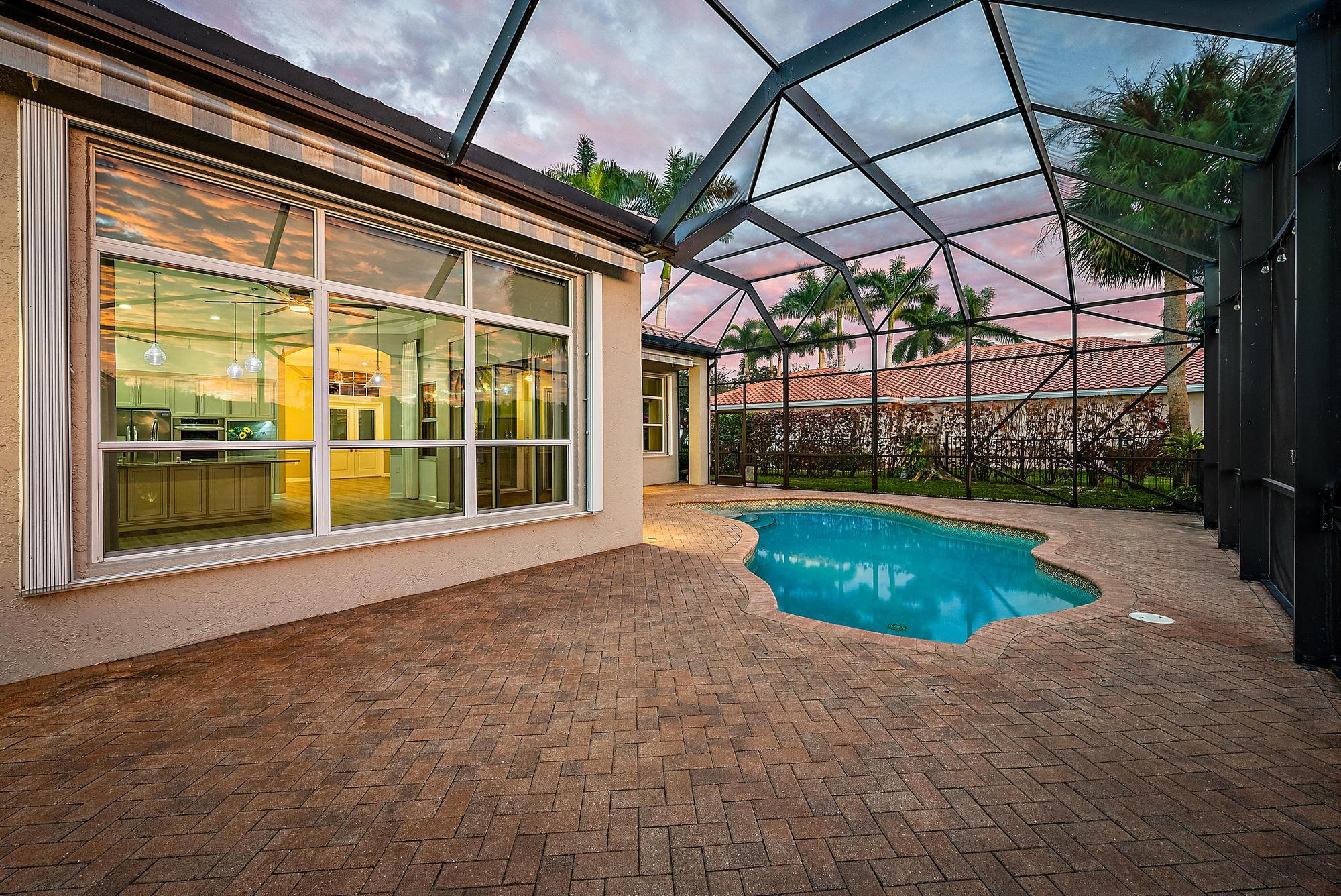 9790 Southeast Crape Myrtle Court Hobe Sound, FL 33455 - Photo 72 of 74 a view of swimming pool with a yard and plants