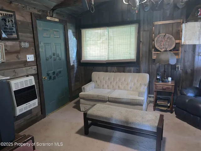 a living room with furniture a fireplace and a window