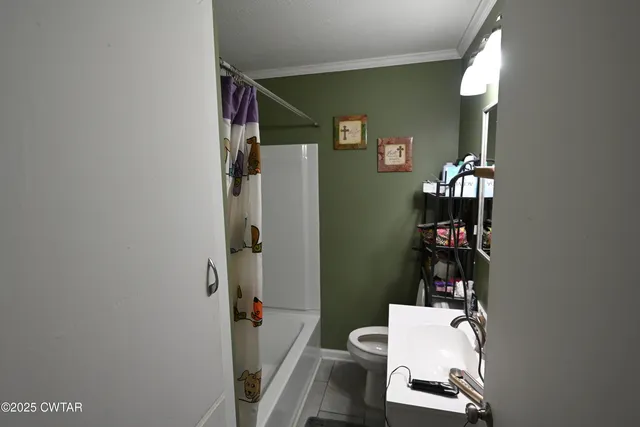 a bathroom with a toilet and a mirror