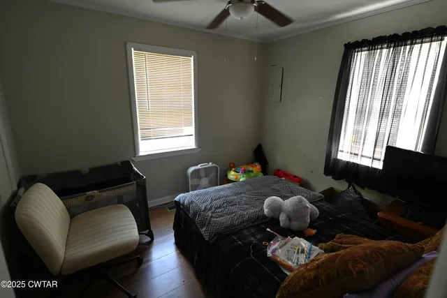 a living room with furniture chess board and a window