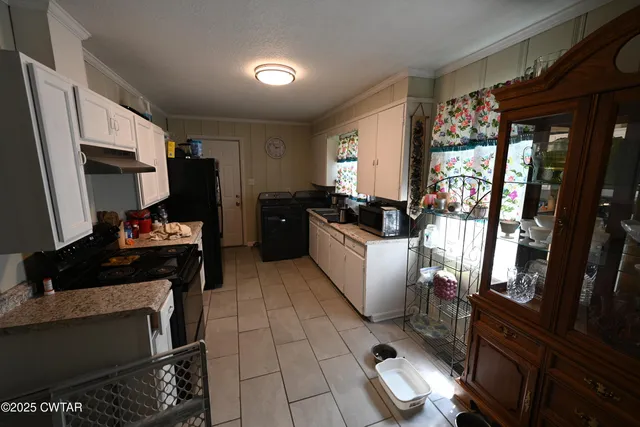 a kitchen with a sink and a stove top oven