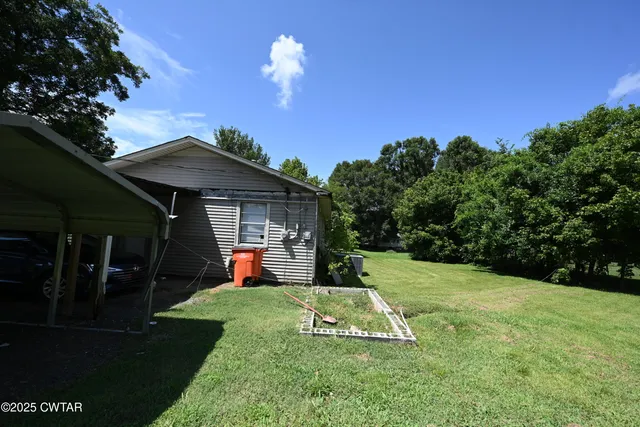 a view of a backyard with a patio