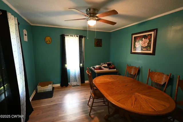 a dining room with furniture and wooden floor