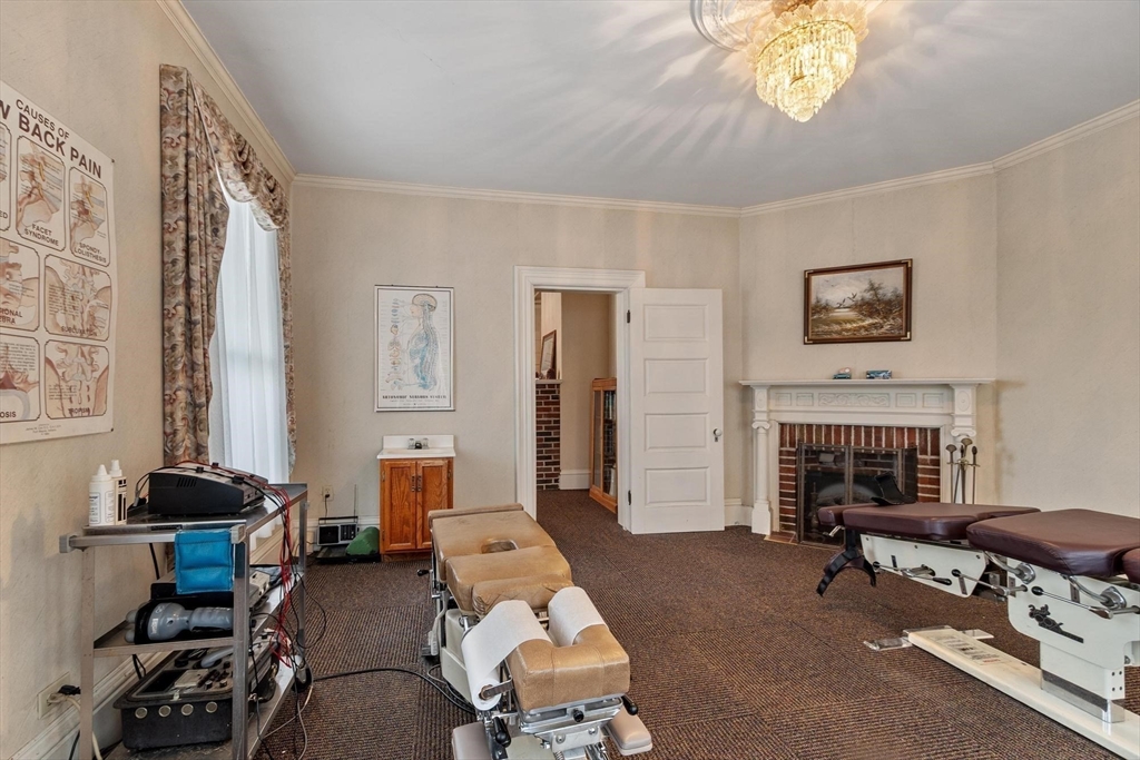 741 Salem Street Lynnfield, MA 01940 - Photo 12 of 41 a living room with furniture a fireplace and a window