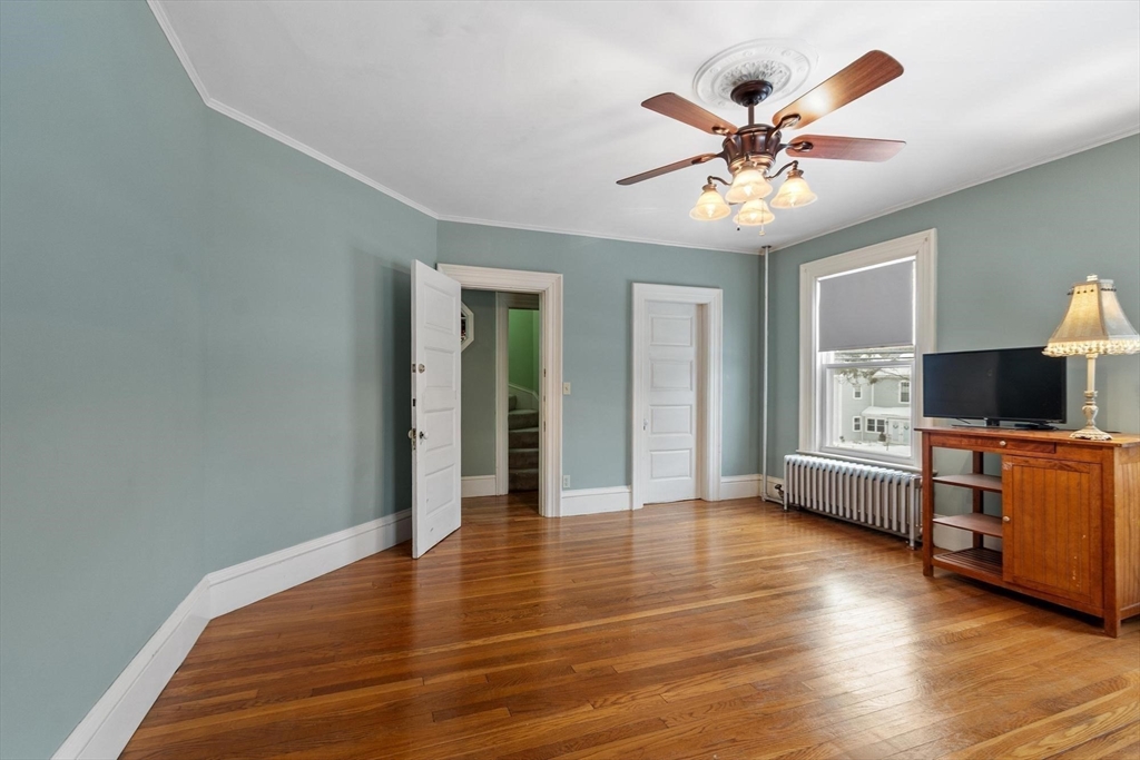 741 Salem Street Lynnfield, MA 01940 - Photo 25 of 41 a view of an empty room with window wooden floor and a chandelier