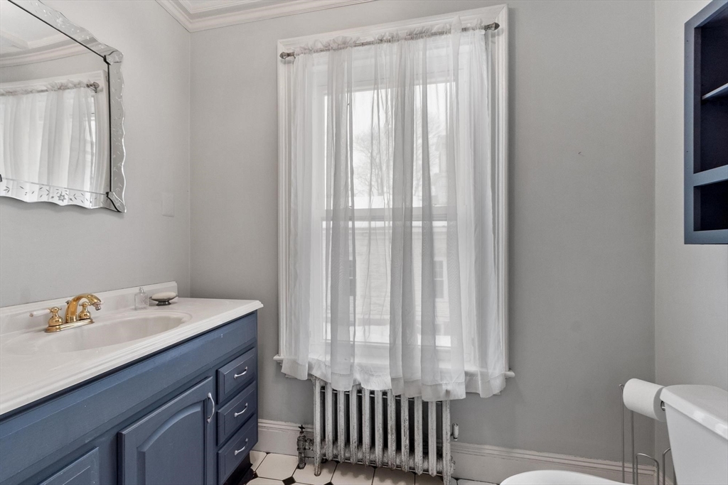 741 Salem Street Lynnfield, MA 01940 - Photo 27 of 41 a bathroom with a sink a toilet and a mirror