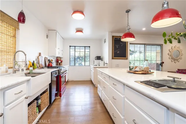 a kitchen with kitchen island granite countertop a sink appliances cabinets and a counter top space