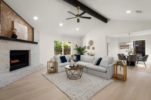 a living room with furniture and a fireplace