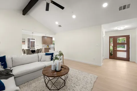 a living room with furniture and a wooden floor