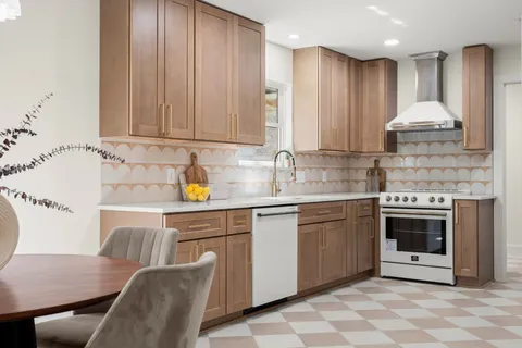 a kitchen with granite countertop a sink stainless steel appliances and cabinets