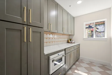 a kitchen with cabinets and window