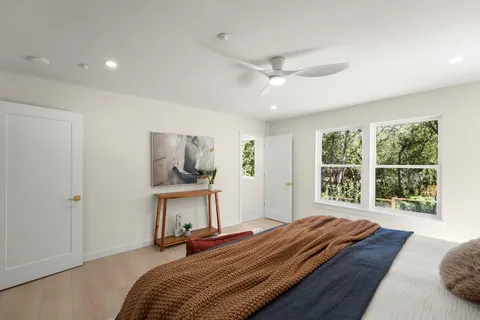 a bedroom with a bed and large window