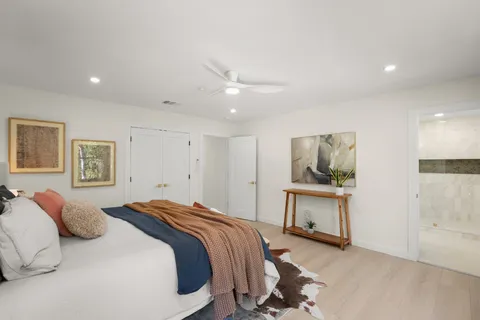a bedroom with a bed and a desk