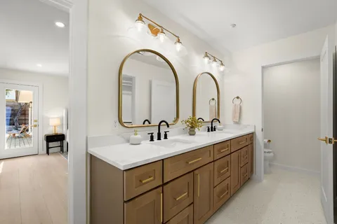 a bathroom with a double vanity sink double and mirror