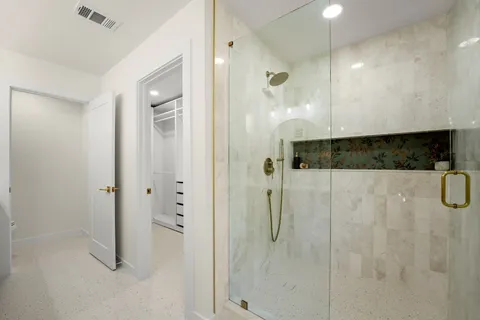 a bathroom with a shower and a sink