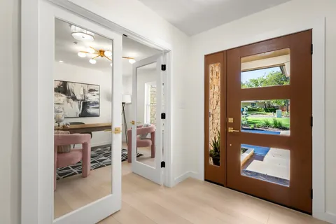 a view of livingroom with furniture front door and wooden floor