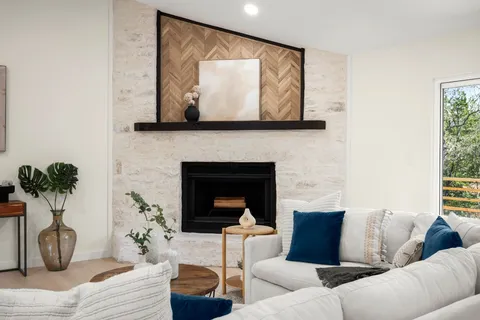 a living room with furniture and a potted plant