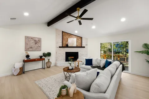 a living room with furniture and a fireplace