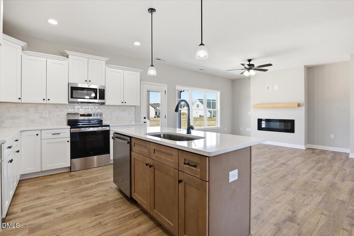 3696 Drew Farmer Road La Grange, NC 28551 - Photo 13 of 35 a kitchen with kitchen island granite countertop a stove a sink a refrigerator and a granite counter tops