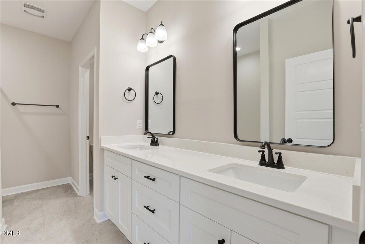 3696 Drew Farmer Road La Grange, NC 28551 - Photo 22 of 35 a bathroom with double vanity sinks and a mirror