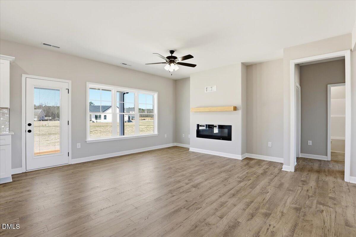 3696 Drew Farmer Road La Grange, NC 28551 - Photo 5 of 35 a view of an empty room with a window and wooden floor