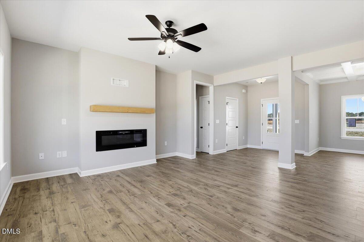 3696 Drew Farmer Road La Grange, NC 28551 - Photo 6 of 35 a view of an empty room with a fireplace and a ceiling fan