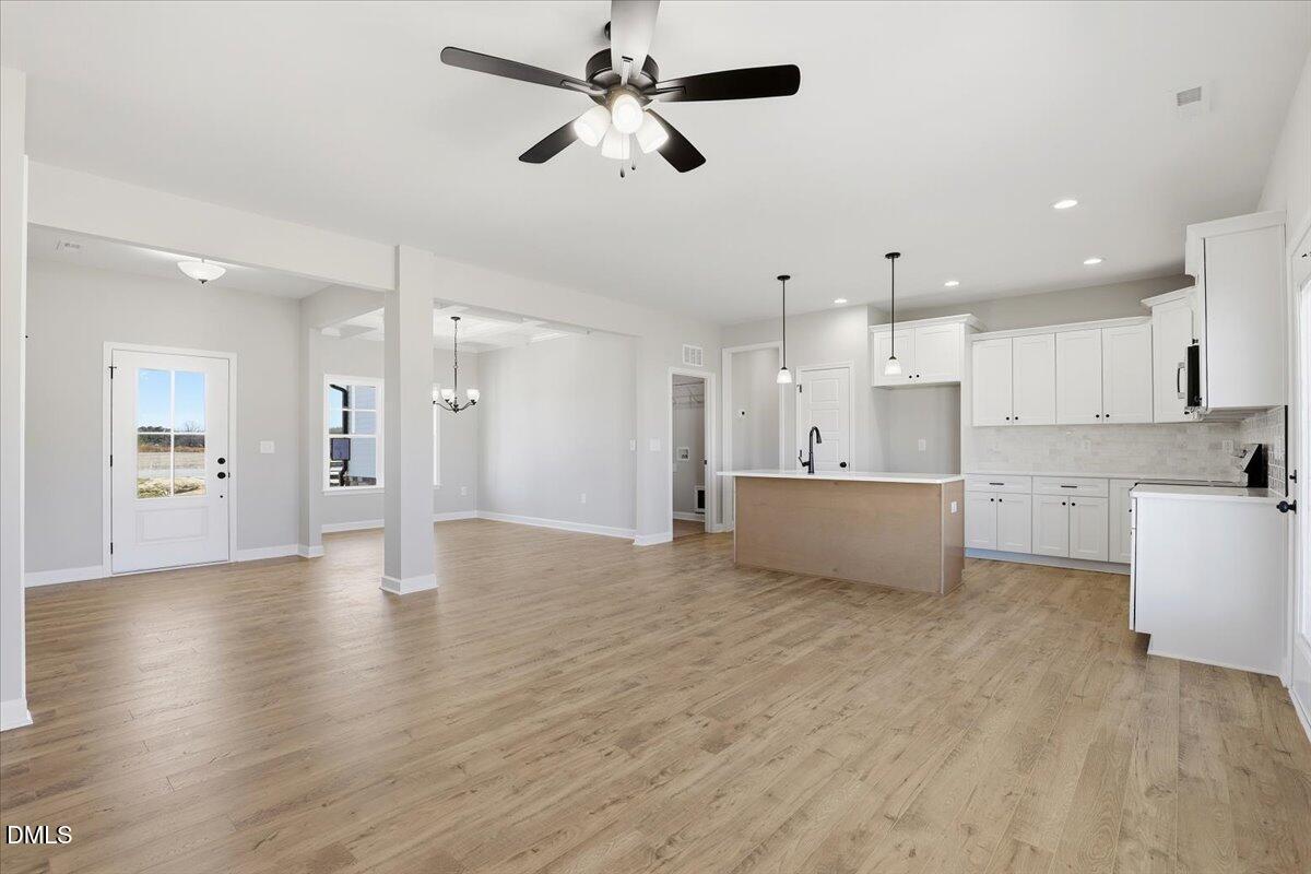 3696 Drew Farmer Road La Grange, NC 28551 - Photo 7 of 35 a view of an empty room and kitchen with wooden floor